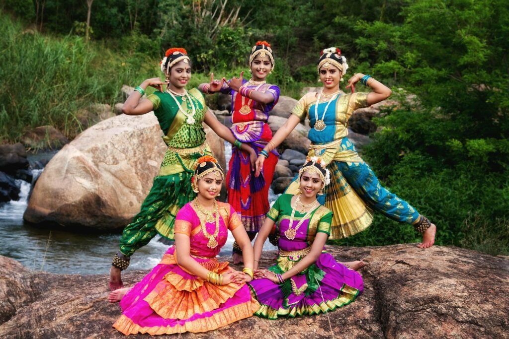 Five dancers in colorful traditional Indian costumes